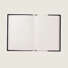 an open book on a white surface with black trimmings and a blank page in the middle