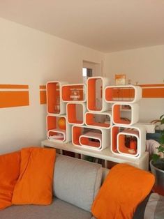 a living room with orange and white decor