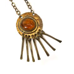 "A hand crafted modernist necklace in brass with dangle decor and glass pendant by Rafael Alfandary. Some tarnishing to chain. Signed on back on pendant. Length (pendant): 3\" Width (pendant): 1-1/2 Length (chain): 16\"" Vintage Hand Forged Brass Jewelry, Handmade Brass Modernist Jewelry, Handmade Modernist Brass Jewelry, Retro Brass Pendant Jewelry, Modernist Bronze Brass Jewelry, Retro Adjustable Brass Jewelry, Adjustable Retro Brass Jewelry, Unique Amber Color Brass Jewelry, Vintage Copper Necklace