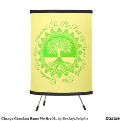 a green and yellow lamp shade with a tree on the bottom that says, you're