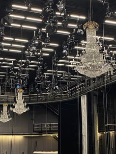 a large chandelier hanging from the ceiling in a room filled with mirrors and lights