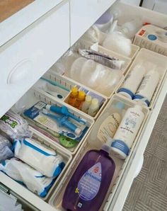 an open drawer filled with lots of baby products and bottles in it's drawers