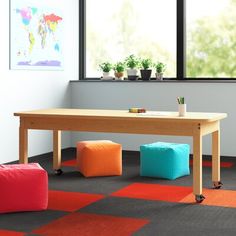 an office with colorful flooring and furniture in the room, including two bean bag stools