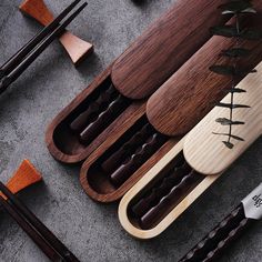 an assortment of chopsticks and knives laid out on the ground