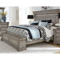 a bedroom with a bed, dresser and night stand in it's center area