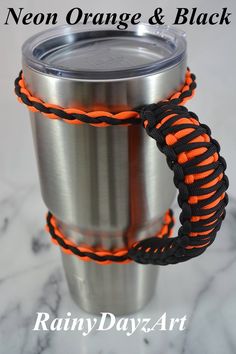 an orange and black rope wrapped around a stainless steel coffee cup with the words neon orange & black on it