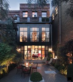 an outdoor dining area is lit up at night