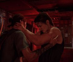 two people in a room with red lights and one person holding his arm around the other