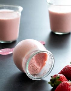 some strawberries and milk are sitting on a table