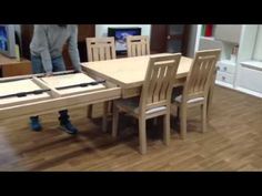 a person standing next to a table with chairs