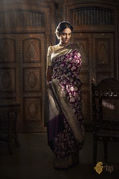 "Anuradha - \"Expectation\"\nThis saree is a vision... each handwoven thread proof of human artistry. An exquisite, full kadhua floral jangla, incredible in its details, handwoven on resplendent silk.\n\n\n Color\u00a0- A regal shot colour with a warp of Black and a weft of Magenta\n\n Technique\u00a0- An enduring Kadwa weave and fine Meenakari technique. The elaborate and laborious Kadwa (Kadhua) technique involves hand-weaving each motif separately. It takes longer on the handloom, but makes a more robust pattern, which stands out on the fabric. Meenakari involves the painstaking addition of supplementary coloured resham threads during the hand-weaving process.\n\n\n Fabric\u00a0- Pure Katan Silk\n\n Speciality\u00a0- A stunning allover kadwa jaal makes this a fabulous and lasting piece Contemporary Saree, Lehenga Red, Dresses Traditional, Weave Styles, Editorial Shoot, Product Shoot, Traditional Styles, Saree Photoshoot, Portrait Of A Woman