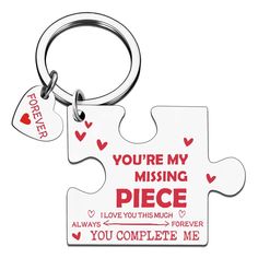 a piece of puzzle keychain with the words you're my missing piece