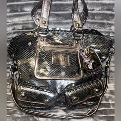 This Bag Is A Limited Poppy Coach Edition. It Is Absolutely Stunning And I Carried It Once. It’s Basically Brand New And Is Not Available In Stores Now. Inside Is Lavender And Outside Is Silver Sequins With Cute Keychain Like Accessories. Luxury Silver Bag With Removable Pouch, Silver Satchel Bags With Gunmetal Hardware, Party Shoulder Bag In Silver With Gunmetal Hardware, Silver Shoulder Bag With Gunmetal Hardware For Party, Silver Party Shoulder Bag With Gunmetal Hardware, Coach Silver Shoulder Bag, Coach Silver Shoulder Bag With Gunmetal Hardware, Coach Silver Bag With Gunmetal Hardware, Silver Coach Bags With Gunmetal Hardware