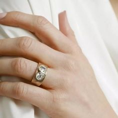 a woman's hand with a ring on it