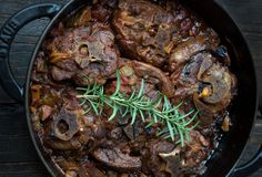 a skillet filled with meat and mushrooms