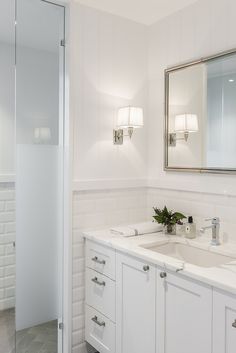 a bathroom with two sinks and a large mirror