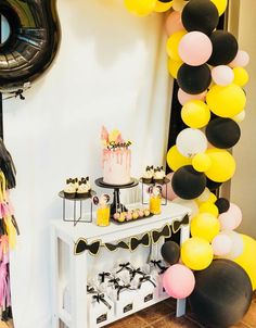 a birthday party with balloons, cake and decorations