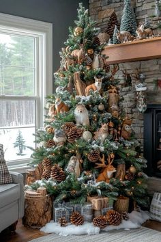 a decorated christmas tree in front of a fireplace with pine cones and other decorations on it