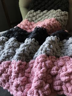 a crocheted blanket sitting on top of a chair