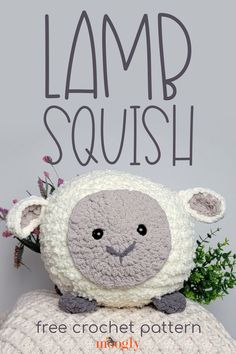 a stuffed sheep sitting on top of a pillow with the words lamb squish written above it