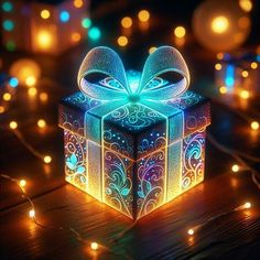 a glowing gift box with a bow on it sitting on a table surrounded by lights