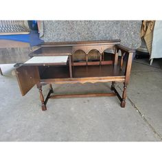 an old wooden desk sitting on the ground