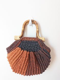 This is a beautiful crocheted small purse/clutch.  it fits all of your essentials with a magnetic closure and bamboo handles.  Great accessory to any every day outfit or a special night out with the girls. Crochet Bag With Bamboo Handle For Everyday Use, Everyday Use Crochet Bag With Bamboo Handle, Chic Brown Crochet Straw Bag, Everyday Crochet Bag With Bamboo And Round Handle, Handheld Brown Crochet Bag With Bamboo Handle, Brown Handheld Crochet Bag, Bohemian Brown Crochet Bag With Bamboo Handle, Brown Handheld Crochet Bag With Bamboo Handle, Luxury Brown Crochet Woven Bag