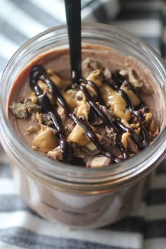 a chocolate dessert in a glass with a spoon