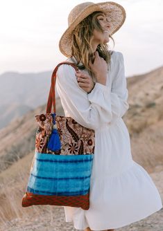 A show-stopping statement bag inspired by some of our favorite vintage designs. Our tie dye patchwork tote bag features a large tassel accent and a snap closure. FINAL SALE Mixed media patchwork Tie-dye Paisley Snap closure Large tassel accent Dimensions: 15" x 20"Style: DR-2105-2 Bohemian Patchwork Bags For Summer, Summer Travel Bag With Patchwork, Blue Summer Bag With Tassels, Summer Patchwork Bags For Daily Use, Summer Travel Shoulder Bag With Patchwork, Bohemian Blue Hobo Tote Bag, Brown Cotton Bags For Vacation, Summer Patchwork Bags For Everyday Use, Summer Patchwork Tote Bag