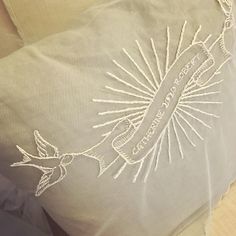 a close up of a pillow with an embroidered design on the front and back of it