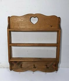 an old wooden shelf with hearts on it