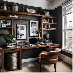 a home office with black walls and wooden shelves filled with books, pictures, and plants