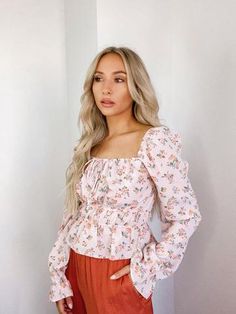 Turn heads in our Tati Floral Top. The feminine top is made from a lightweight... Blush Fabric, Staple Tops, Floral Babydoll Top, Pink Floral Top, Floral Ruffle Top, Floral Print Crop Top, Thrifted Outfits, Feminine Top, Long Sleeve Floral Top