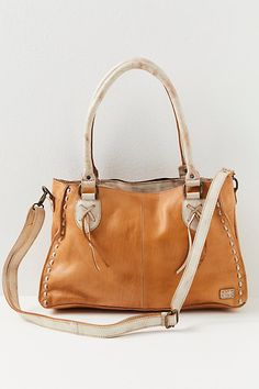 Handmade in Mexico, this forever-timeless tote is featured in a soft vegetable tanned leather and slouchy silhouette with a removeable crossbody strap, top zip closure, and exterior pocket. * Handmade * Zippered interior pockets * Adjustable crossbody strap | Bed Stu Rockababy Tote Bag at Free People in Brown Everyday Textured Leather Tote Satchel, Leather Hobo Bag With Detachable Handle For Fall, Fall Leather Hobo Bag With Detachable Handle, Leather Double Handle Hobo Bag For Fall, Leather Satchel With Handles For Fall, Daily Use Textured Leather Tote Satchel, Leather Embossed Satchel Tote, Textured Leather Tote Satchel For On-the-go, Cognac Smooth Grain Tote Satchel