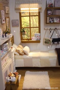 a doll house bedroom with white furniture and accessories on the floor, including a small bed