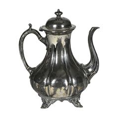 an antique silver tea pot on a white background