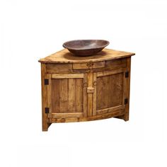 a bowl on top of a wooden cabinet with doors and drawers in the shape of a door