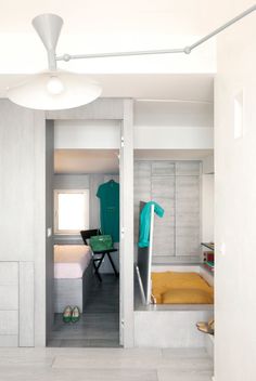 an open door leading to a bedroom with white walls