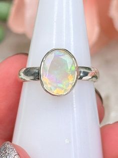 Sterling Silver Ethiopian Dry Opal rings with faceted oval stones and simple silver bands. You will get to choose your exact ring! They are perfect for daily wear or a special occasion. All have beautiful colors, mostly in the yellow, green and blue shades, but a couple have a little red too. The video is going to be the best thing to look at! You will receive the exact opal ring you choose in the menu. The photos will not update to the assigned piece like my site normally does. --- Be sure to check out all of the other crystal rings and crystal jewelry on the website too! --- Learn about crystal properties on the 'Crystal Quick Facts' page. Orders are packed with love, care, & free gifts. Colors may vary due to the screen. See FAQ for more.Follow @contempocrystals on IG!! Thanks!! Oval Faceted Crystal Promise Ring, Oval Faceted Birthstone Ring For Anniversary, Adjustable Oval Stackable Rings, Silver Faceted Oval Rings, Silver Faceted Oval Crystal Ring, Faceted Oval Crystal Ring As Gift, Oval Faceted Crystal Ring As Gift, Faceted Oval Crystal Ring For Gift, Iridescent Oval Spiritual Rings