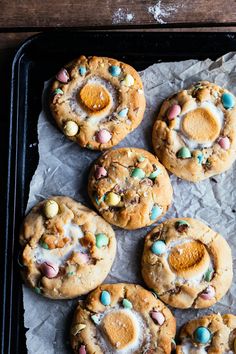 several cookies with eggs and marshmallows are on a baking sheet, ready to be eaten