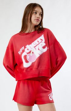 PacSun exclusive! Wrap yourself in retro-cool comfort with the Coca-Cola By PacSun Cherry Coke Boxy Crew Neck Sweatshirt. This laid-back sweatshirt effortlessly blends iconic Coca-Cola vibes with a touch of sweetness, showcasing a playful Cherry Coke graphic on the front. The boxy oversized fit and dropped shoulders add a trendy update, making it the go-to choice for relaxation.    	Solid color sweatshirt 	Long sleeves 	Crew neckline 	Dropped shoulders 	Cherry Coke graphic 	Ribbed trimming 	Boxy oversized fit 	Soft fleece lining 	60% cotton, 40% polyester 	Machine washable 	Model is wearing a size small 	Model measurements: 5’8.5” height, 31.5” bust, 24” waist, 35.5” hips Sweat Shorts Women, Slim Fit Cargo Pants, Cherry Coke, Pop Art Fashion, Color Sweatshirt, Crewneck Sweatshirt Women, Curve Jeans, Jeans Kids, Kids Swimwear