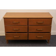 a brown wooden dresser with four drawers