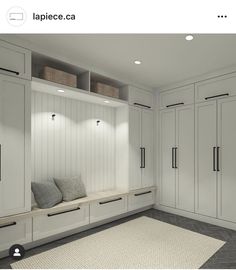 a room with white cabinets and gray carpet