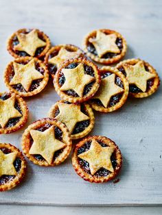 small pies with stars on them are sitting on a cutting board, ready to be eaten