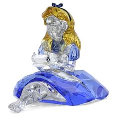 a glass figurine sitting on top of a blue object