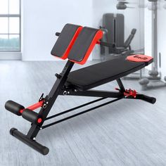 a weight bench with red and black handles