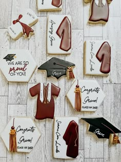 decorated cookies with graduation caps, gowns and tassels are laid out on the floor