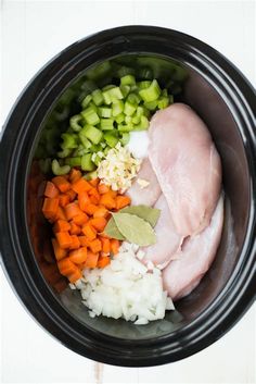 chicken, carrots, celery and onions in a slow cooker bowl