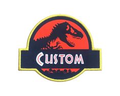 a patch with the word custom printed on it and a t - rex logo in front