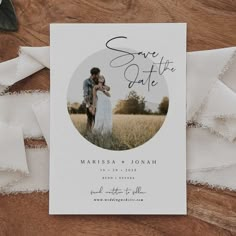 save the date card with an image of a man and woman hugging in a field